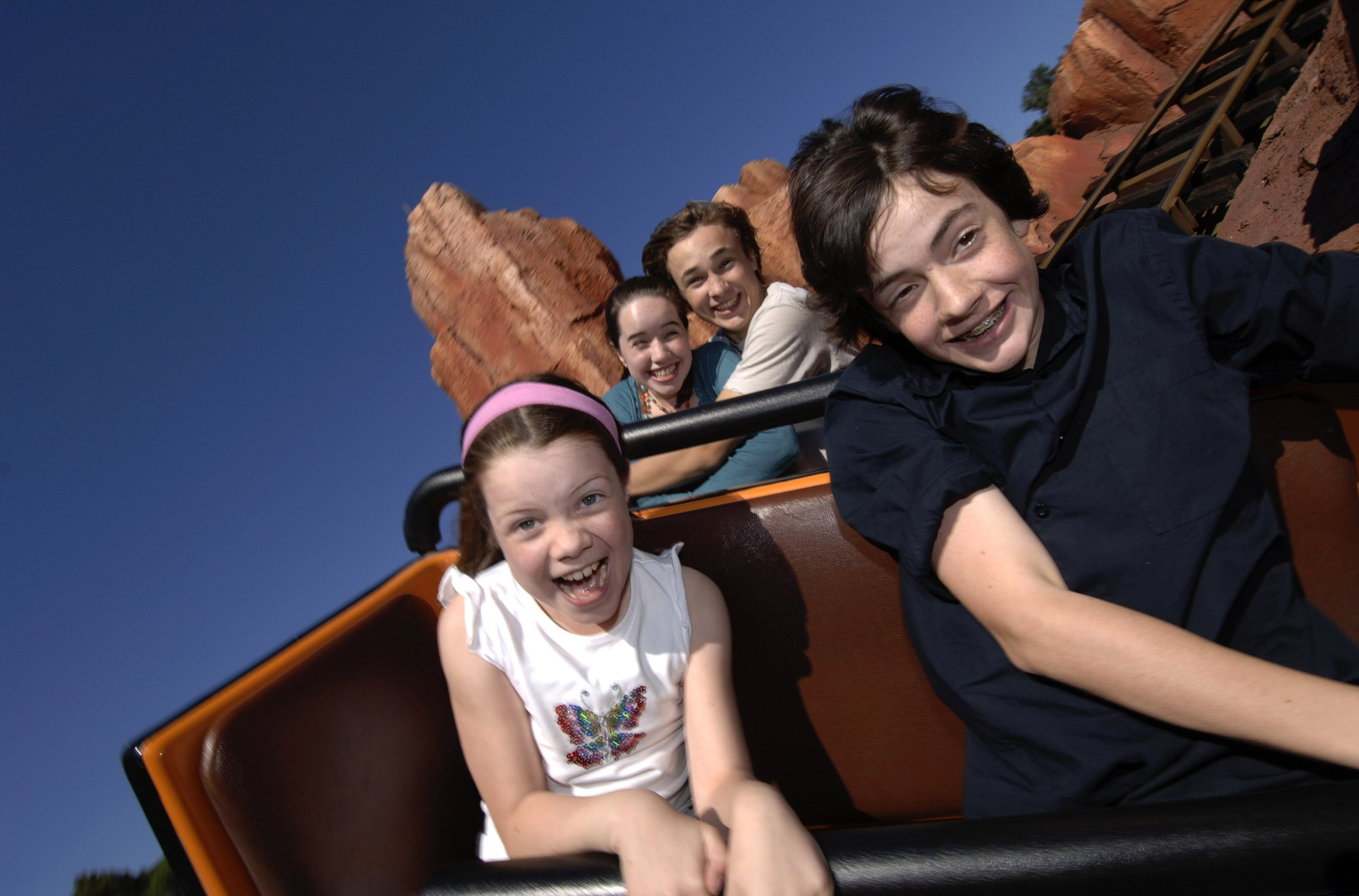 The Four Children having a blast on a rollercoaster 